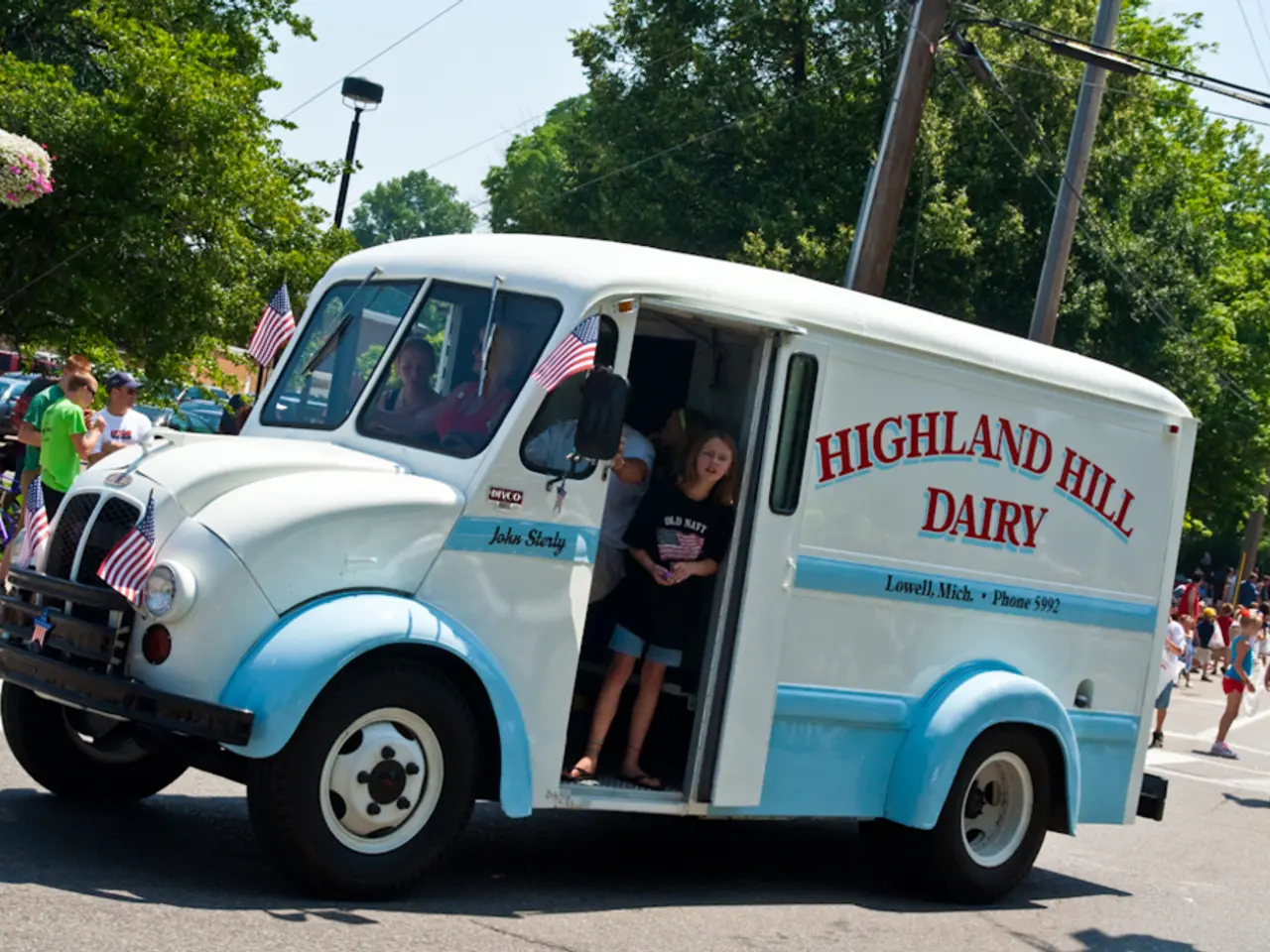 In the center of the picture there is a truck on the road, in the truck there are people. In the...