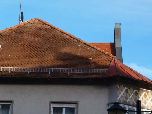 In this image there is a house. Right bottom there are lamps attached to a pole. Background there...