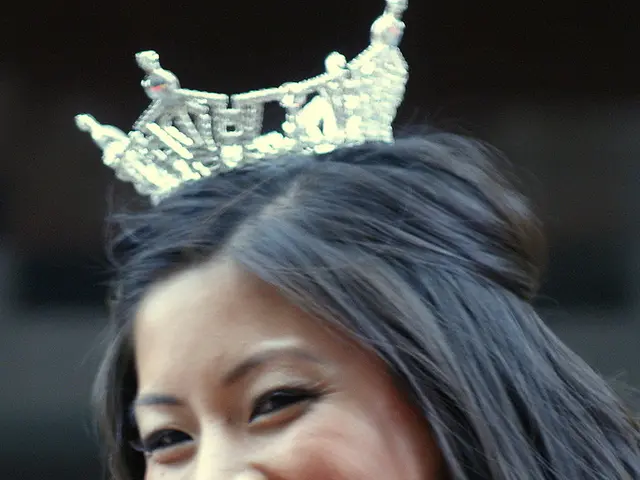 In this image we can see a woman wearing a crown on her head.