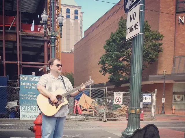 In the image we can see there is a man who is standing and holding guitar in his hand and at the...