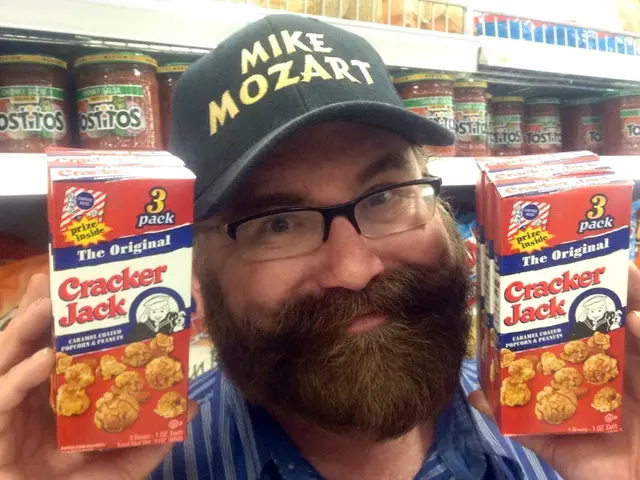 In this image we can see a person and he is holding few objects in his hand. A man is wearing a cap...