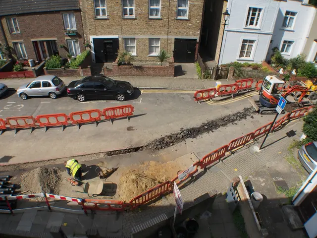 In this picture I can see a man on the road, in the middle there are vehicles, on the right side...