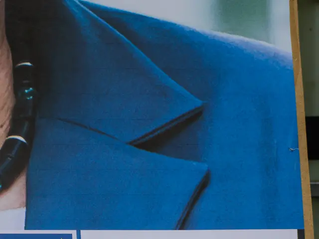 This image consists of a poster on the board. It consists of a man wearing blue suit. At the...
